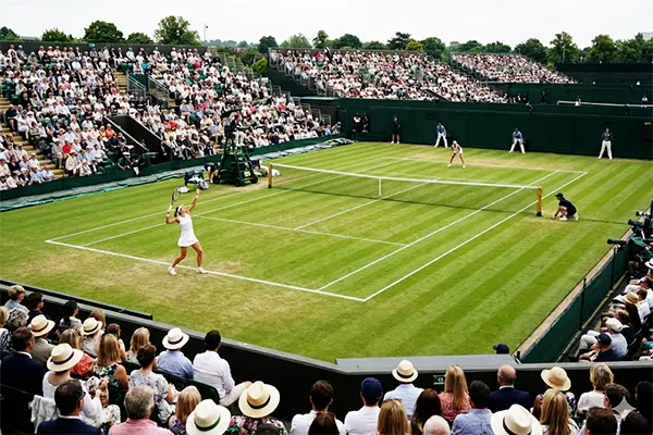 Wide view of Centre Court at the Wimbledon Tennis Championships showing the grass court and surrounding stands Centre Court during the Wimbledon Tennis Championships